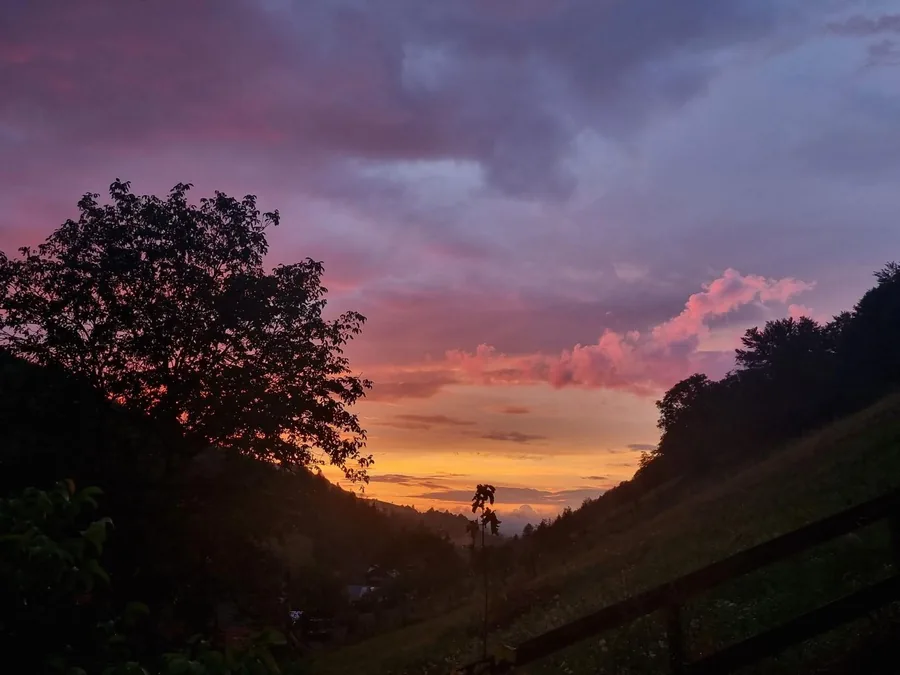 Dramatic purple-orange sunset over the Holbav valley